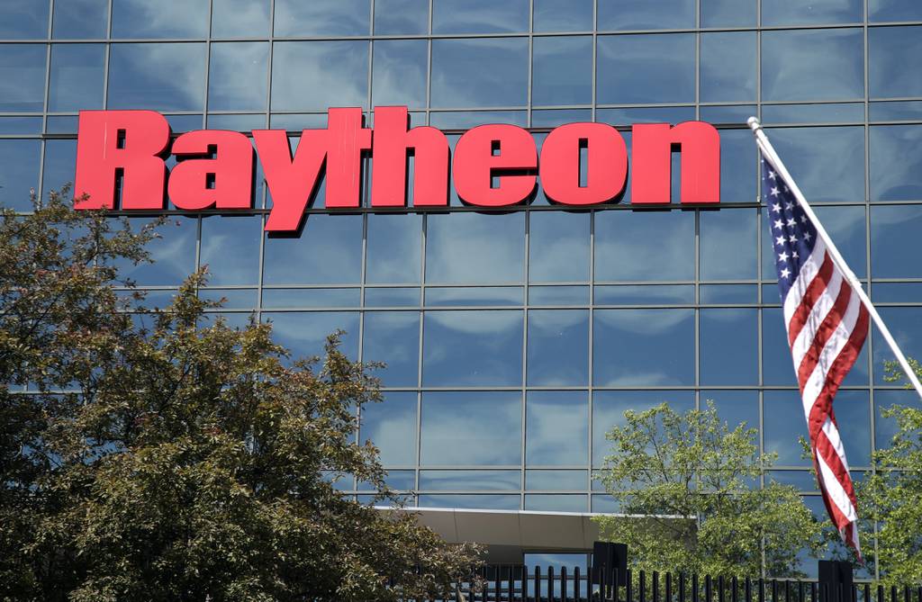 An American flag flies in front of the facade of Raytheon's Integrated Defense Systems facility in Woburn, Mass., June 10, 2019.