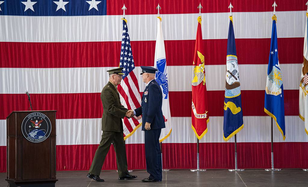 Joint Chiefs of Staff Gen. Joseph F. Dunford Jr., left, shakes hands with Gen. John W. Raymond, the commander of the U.S. Space Command