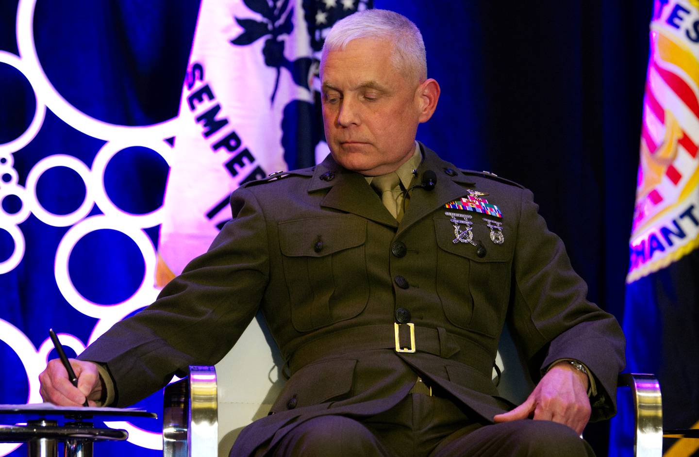 U.S. Marine Corps Brig. Gen. David Walsh, the leader of Marine Corps Systems Command, takes note during a discussion at the Sea-Air-Space conference in National Harbor, Maryland, on April 4, 2023.