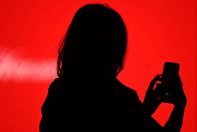 A guest takes a selfie with her smartphone during the Mercedes Benz Fashion Week in Madrid on April 8, 2021.