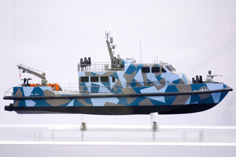 A model of a vessel, draped in blue-and-grey camouflage, is seen suspended at the Fincantieri booth at Sea-Air-Space on April 10, 2024.