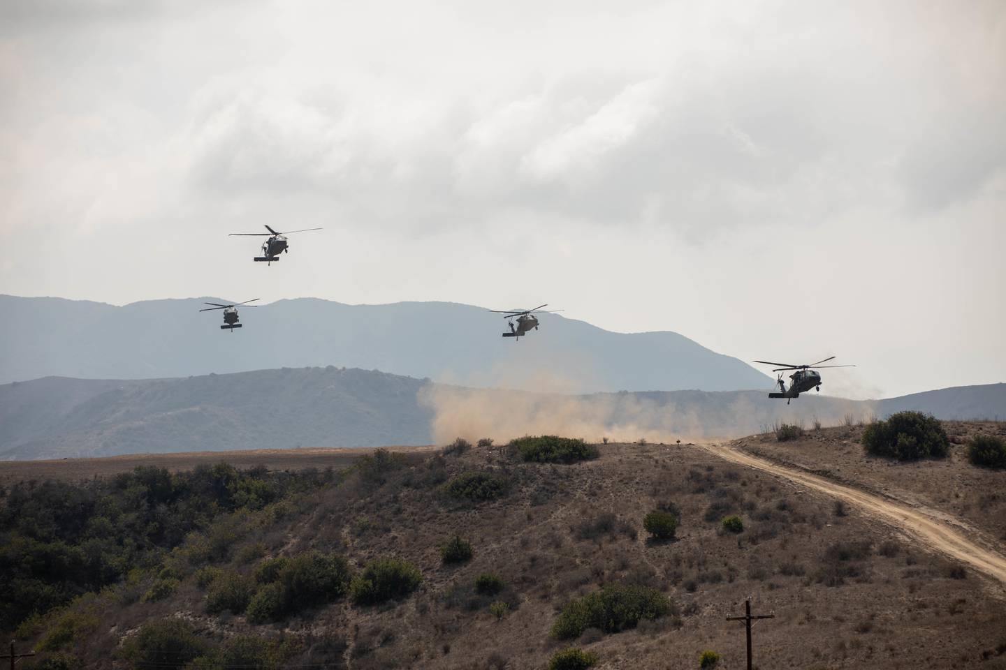 Blackhawks take off with soldiers aboard as they set off for their missions during Project Convergence 2022.